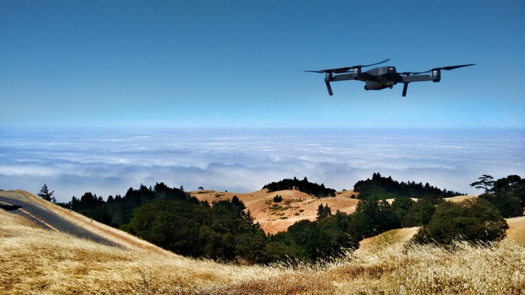 Commercial quadcopter drone flying over hills, symbolizing the Pentagon's Replicator initiative and the shift toward autonomous defense technology driving the stock market boom.