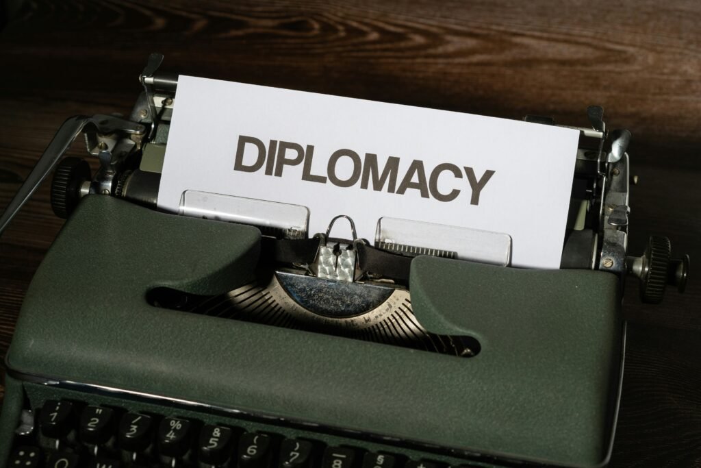 Vintage typewriter with the word diplomacy printed on a white sheet of paper