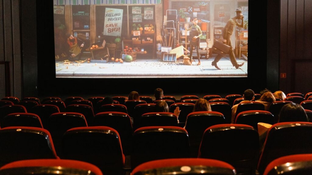 A movie theater auditorium with a glowing screen, illustrating the box office number one opening