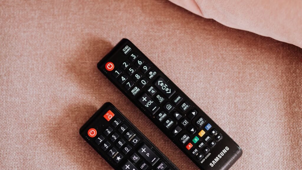 A television remote pointed at a smart TV streaming screen, illustrating the Fox-Roku streaming deal